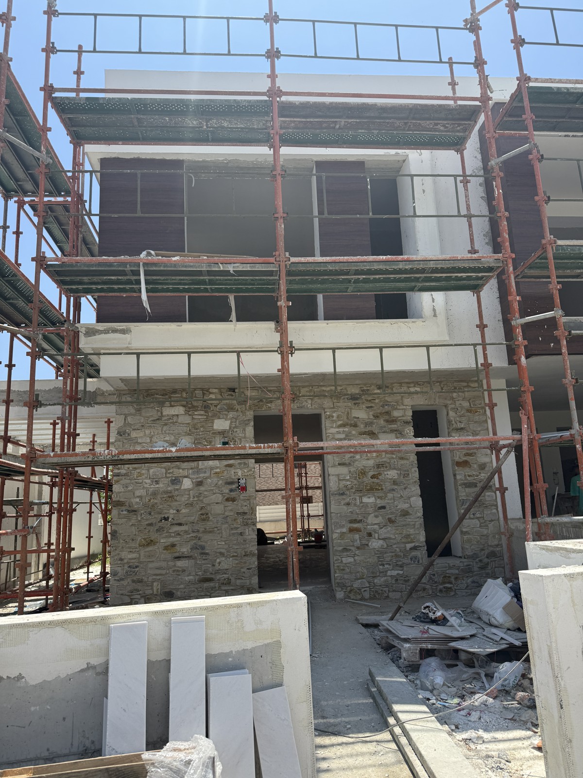 A Cyprus home under construction, with scaffolding around the exterior